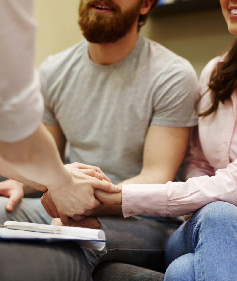 Closeup of young man and woman visiting couples counseling session